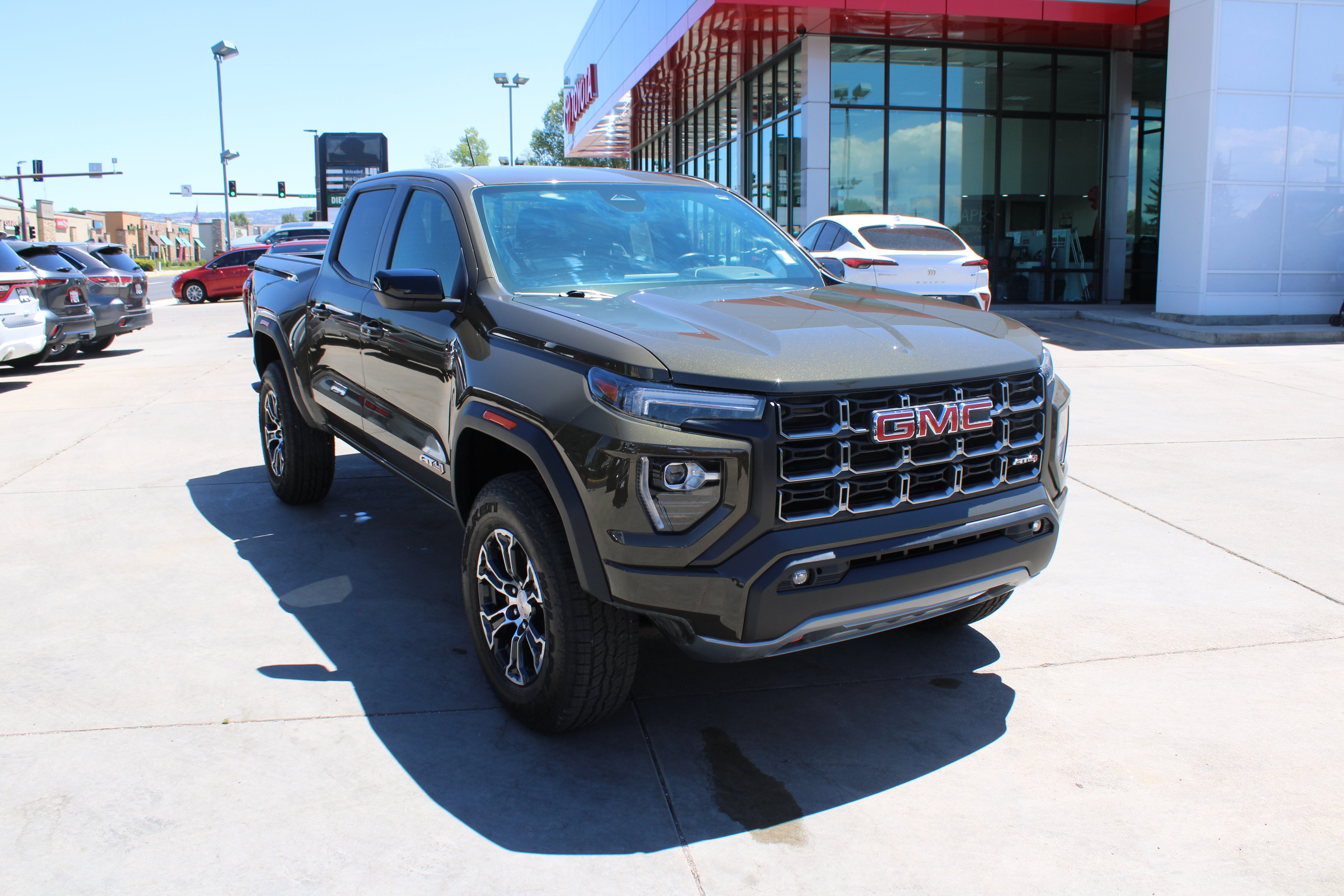 2024 GMC Canyon 4WD AT4 in Deep Bronze Metallic — front three-quarter view